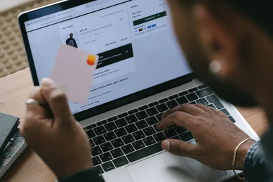 Business owner using a laptop with a visible call-to-action button on a website, representing conversion-focused web design and optimized lead generation strategy for service-based businesses.